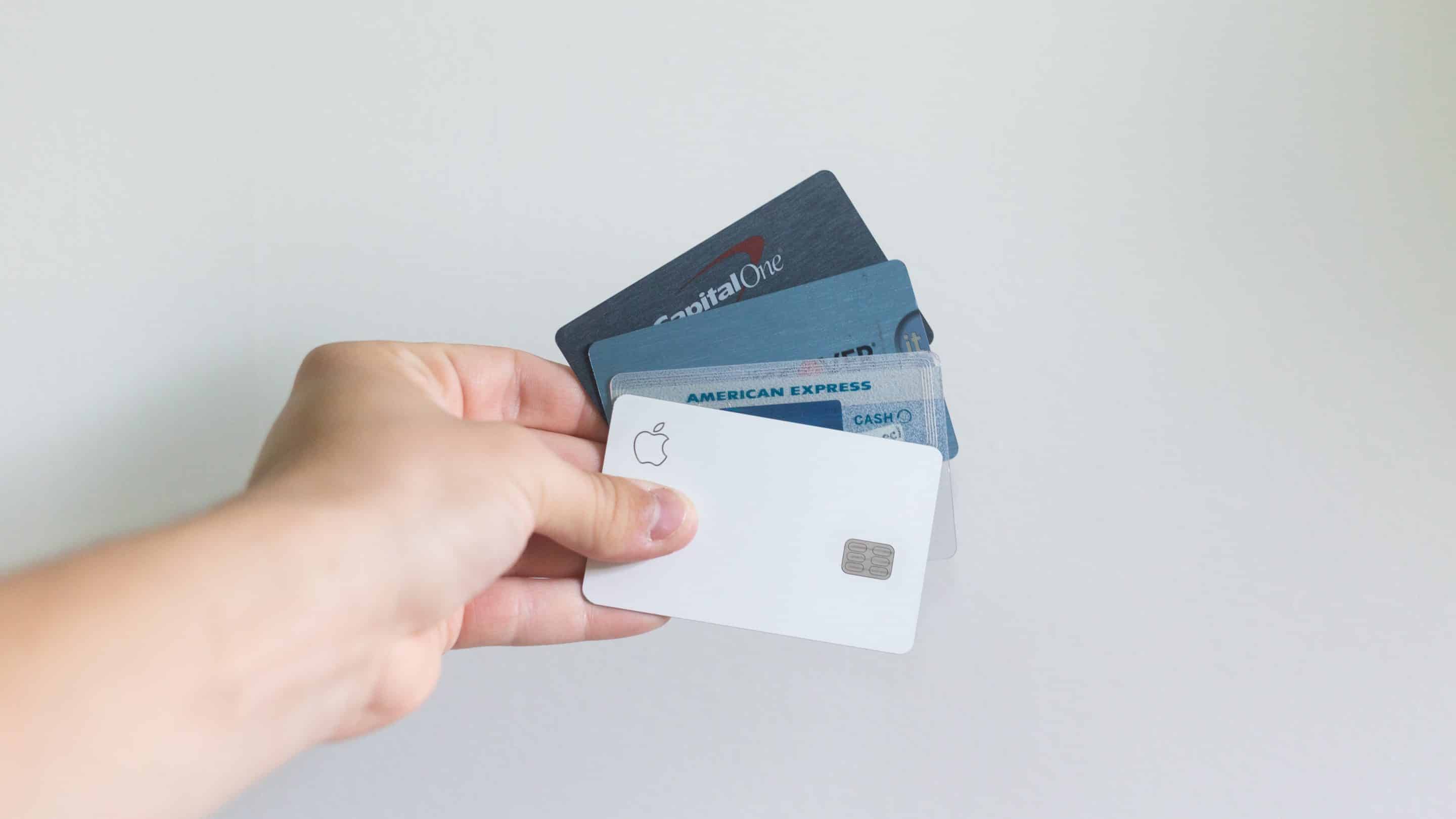 A hand holding multiple credit cards