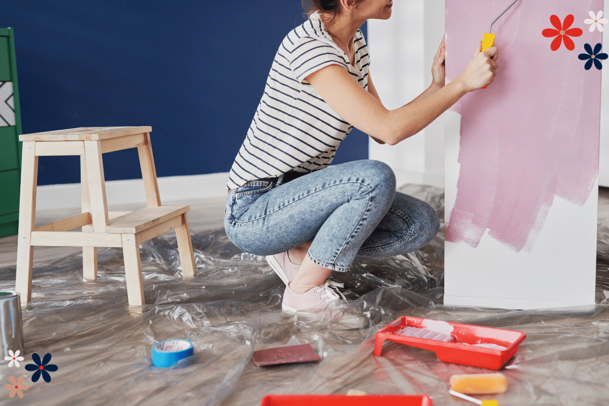 bored stuff to do A woman squatting and painting a wall pink