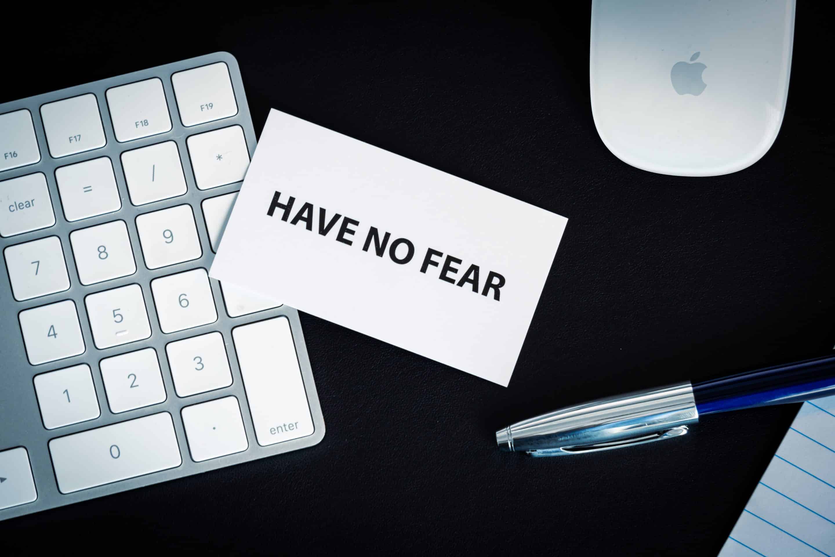 A business card that reads Have No Fear sitting on top of a keyboard