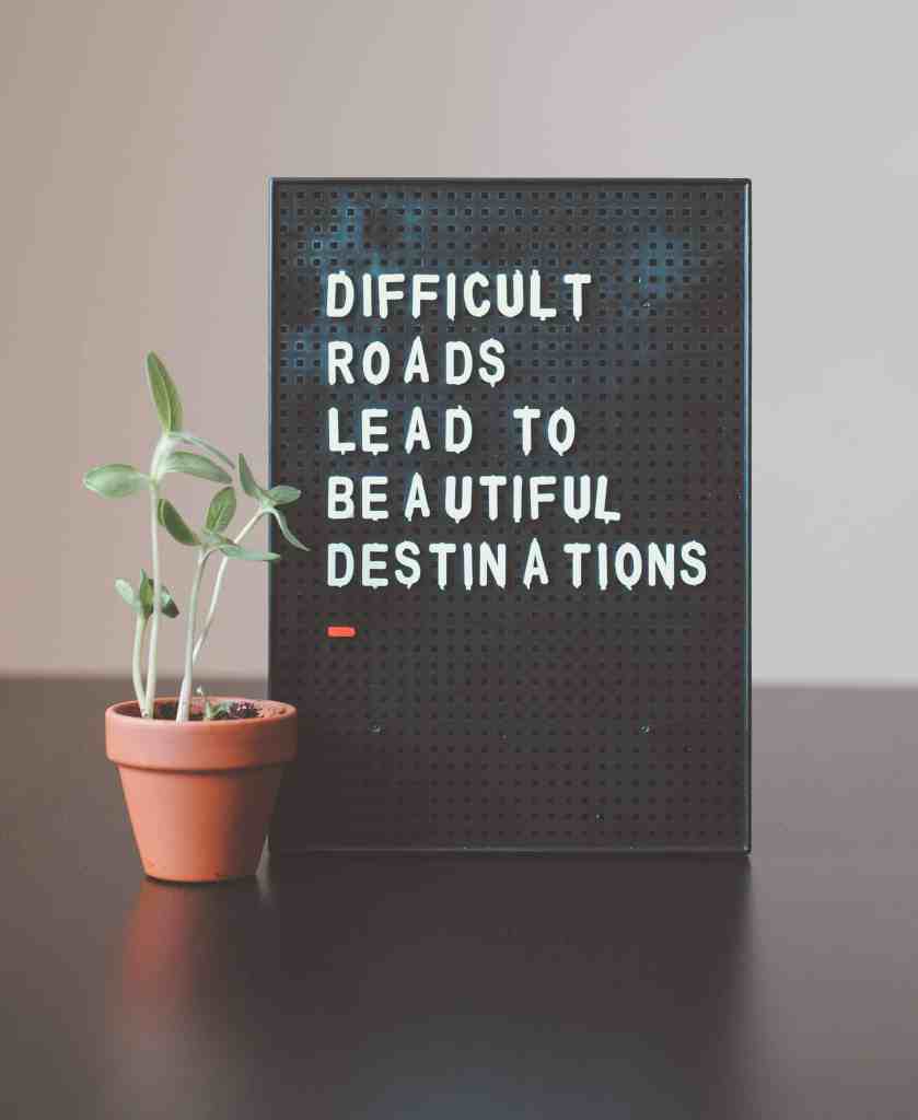 A board that reads difficult roads lead to beautiful destinations