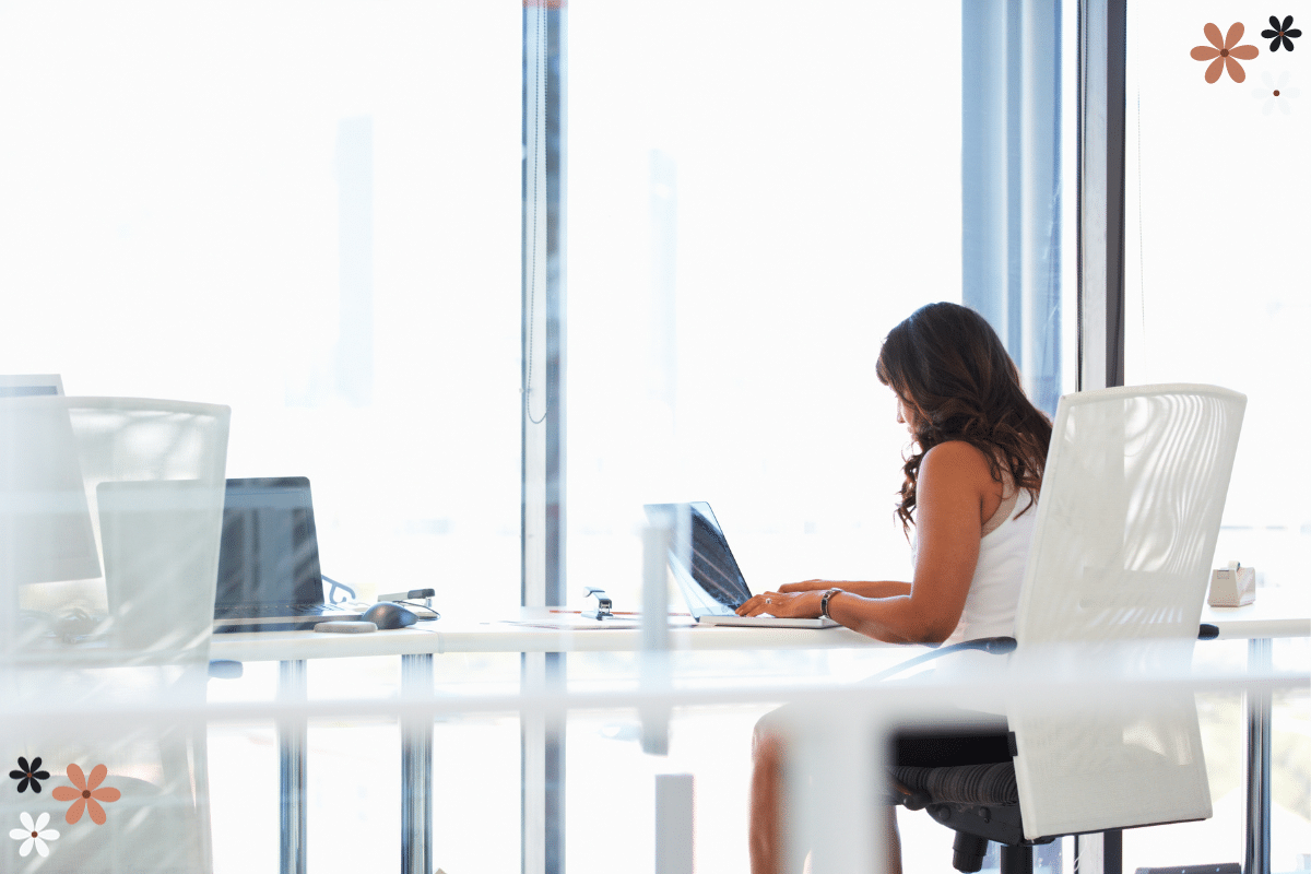 mean girls at work A woman sitting alone at a glass table with empty chairs around her