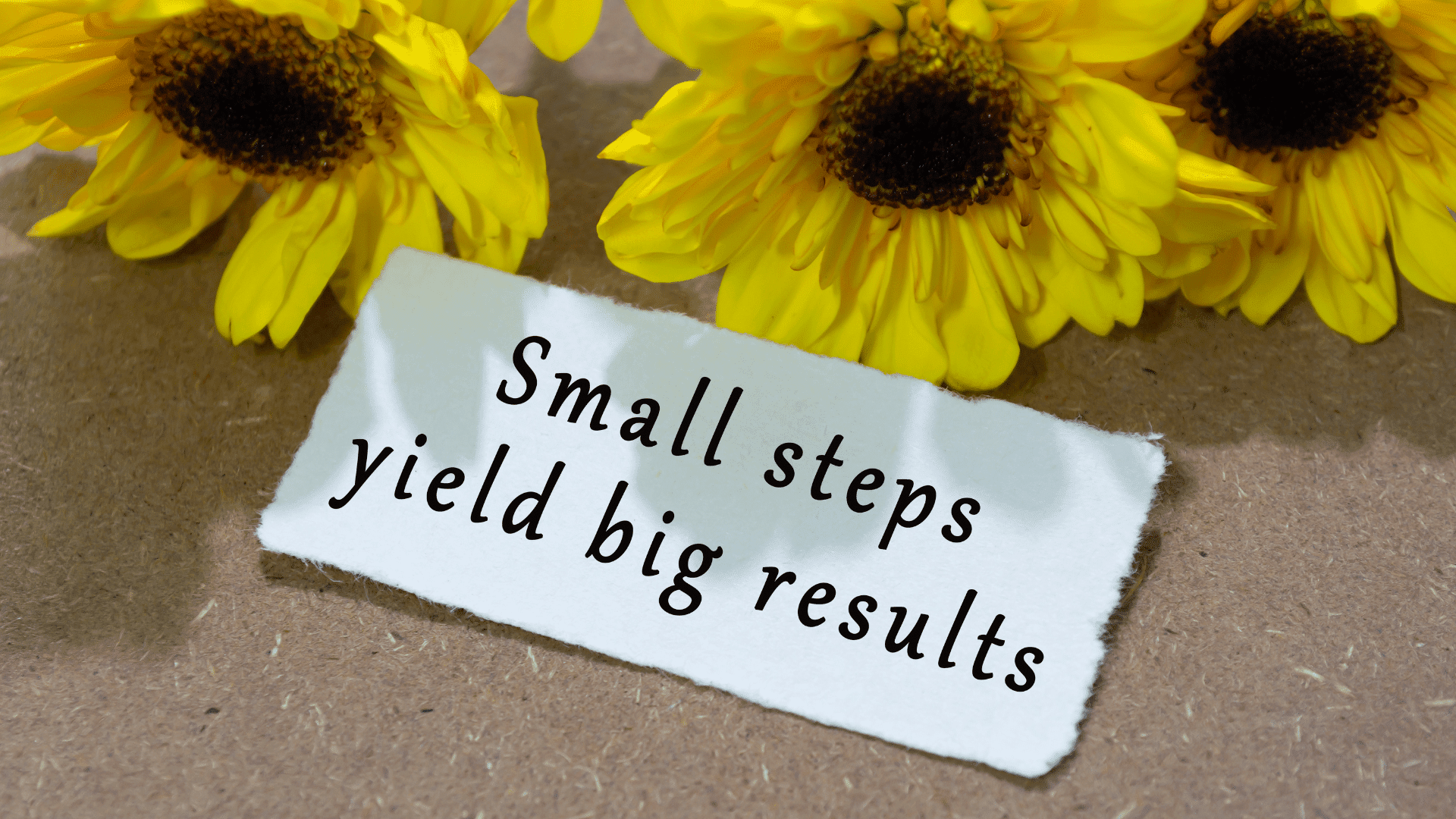 Steps Sunflowers behind a sign that reads small steps yield big results