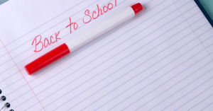 A piece of paper with the words Back to school writing in red pen