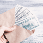 An envelope of multiple one hundred dollar bills