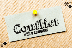 A pinned sign that reads conflict with a coworker
