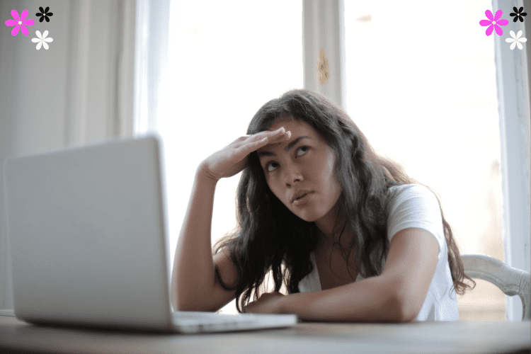 Annoyed woman sitting in front of a laptop at a desk