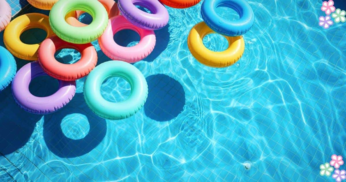 Colorful inflatable pool rings floating in a swimming pool for a kids pool party