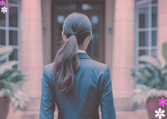 Woman in a business suit walking towards a building